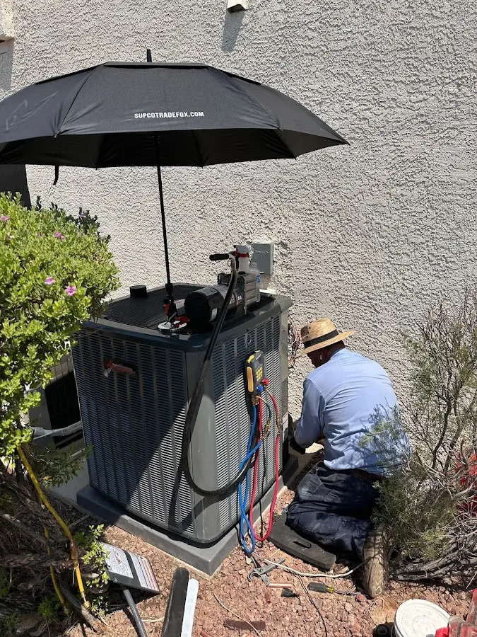 HVAC technician performing outdoor AC maintenance in Upper Pottsgrove